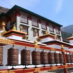 Thupten Choling Monastery with prayer wheels in the foreground